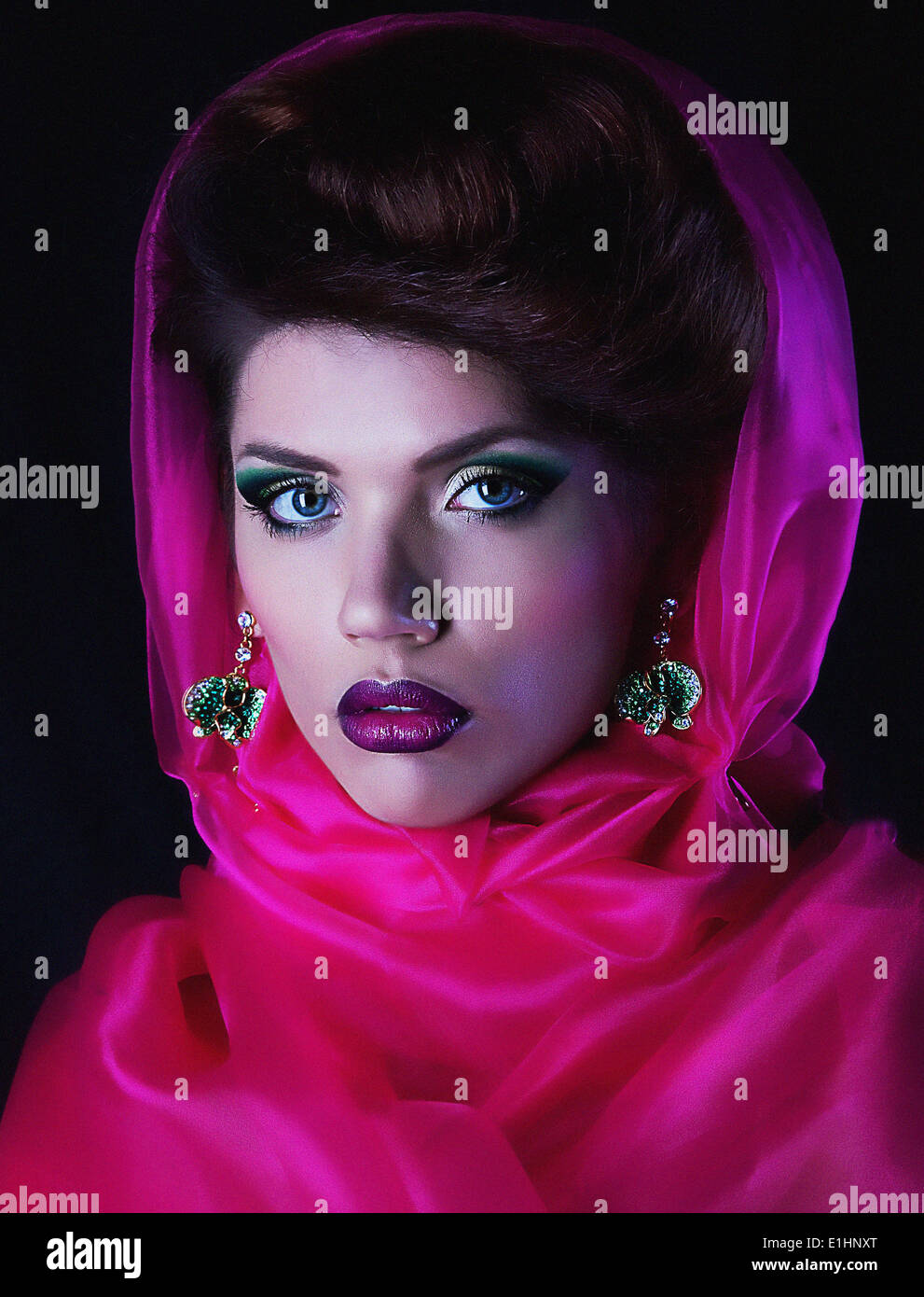 Art portrait of attractive girl brunette in a crimson cape closeup Stock Photo