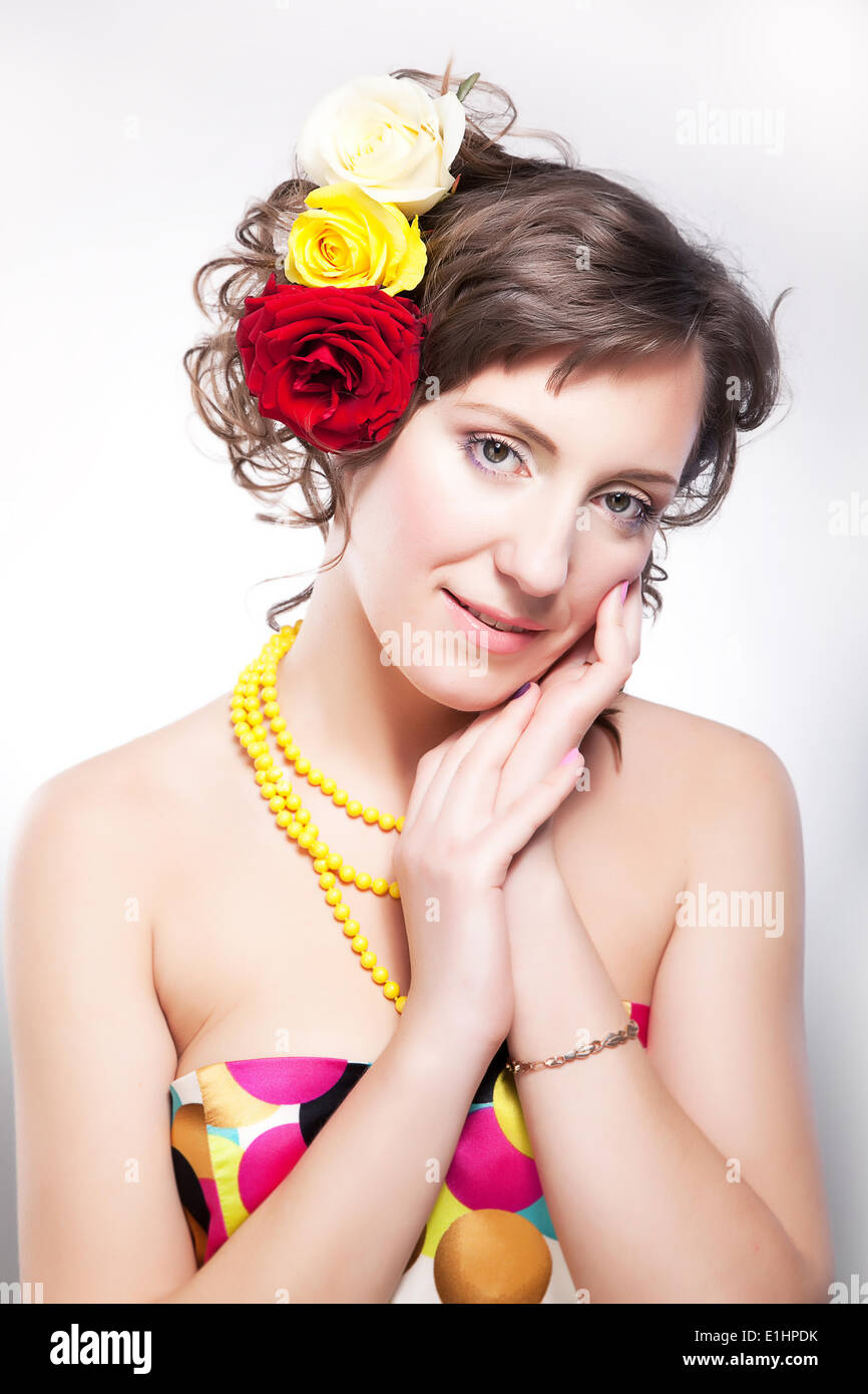 Beautiful female - vernal happy young girl with flowers posing in studio Stock Photo