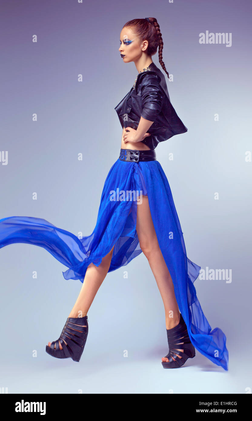 Fashion female posing in contemporary blue dress (gown) Stock Photo