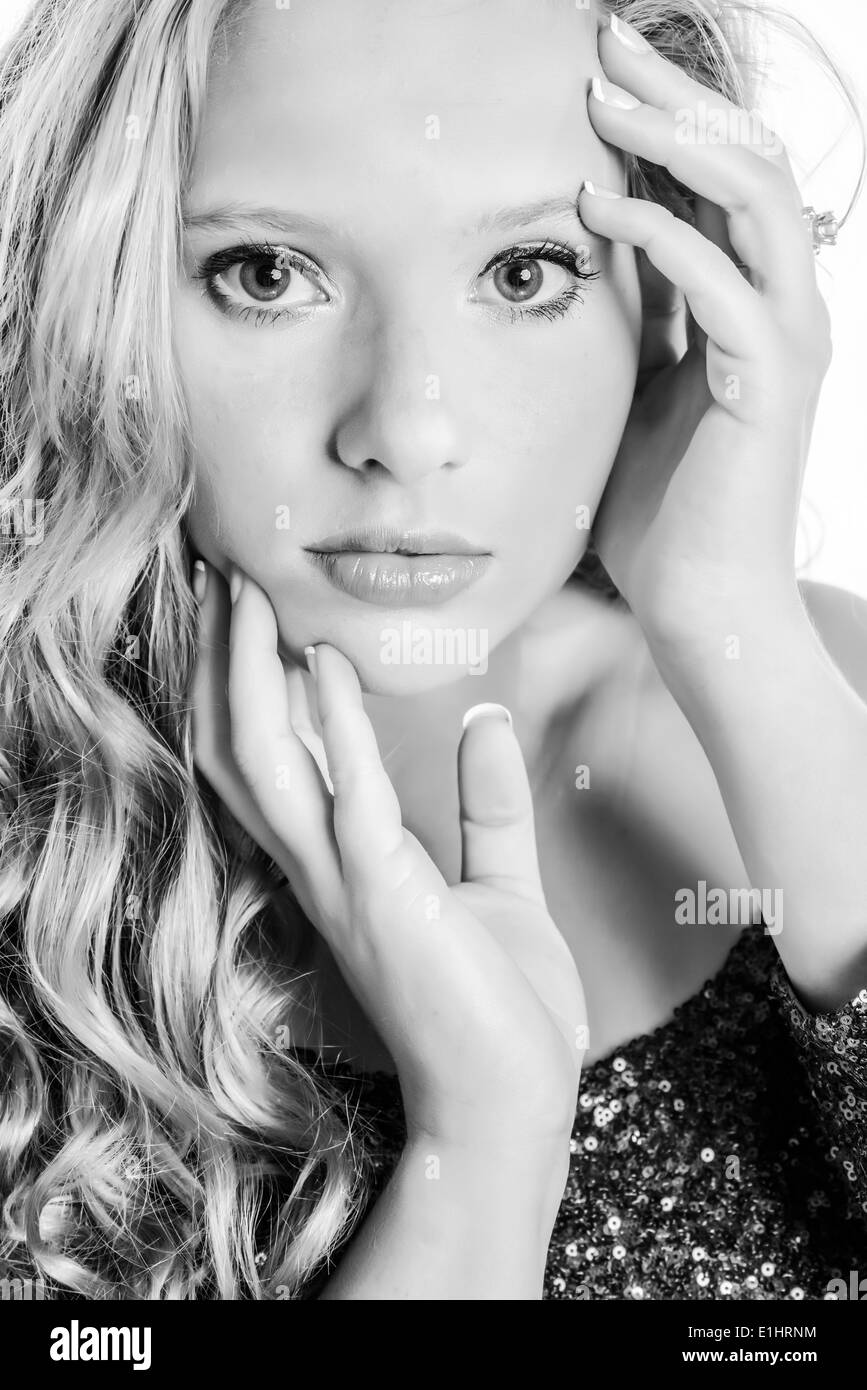 Portrait of young woman with hands on her face Stock Photo