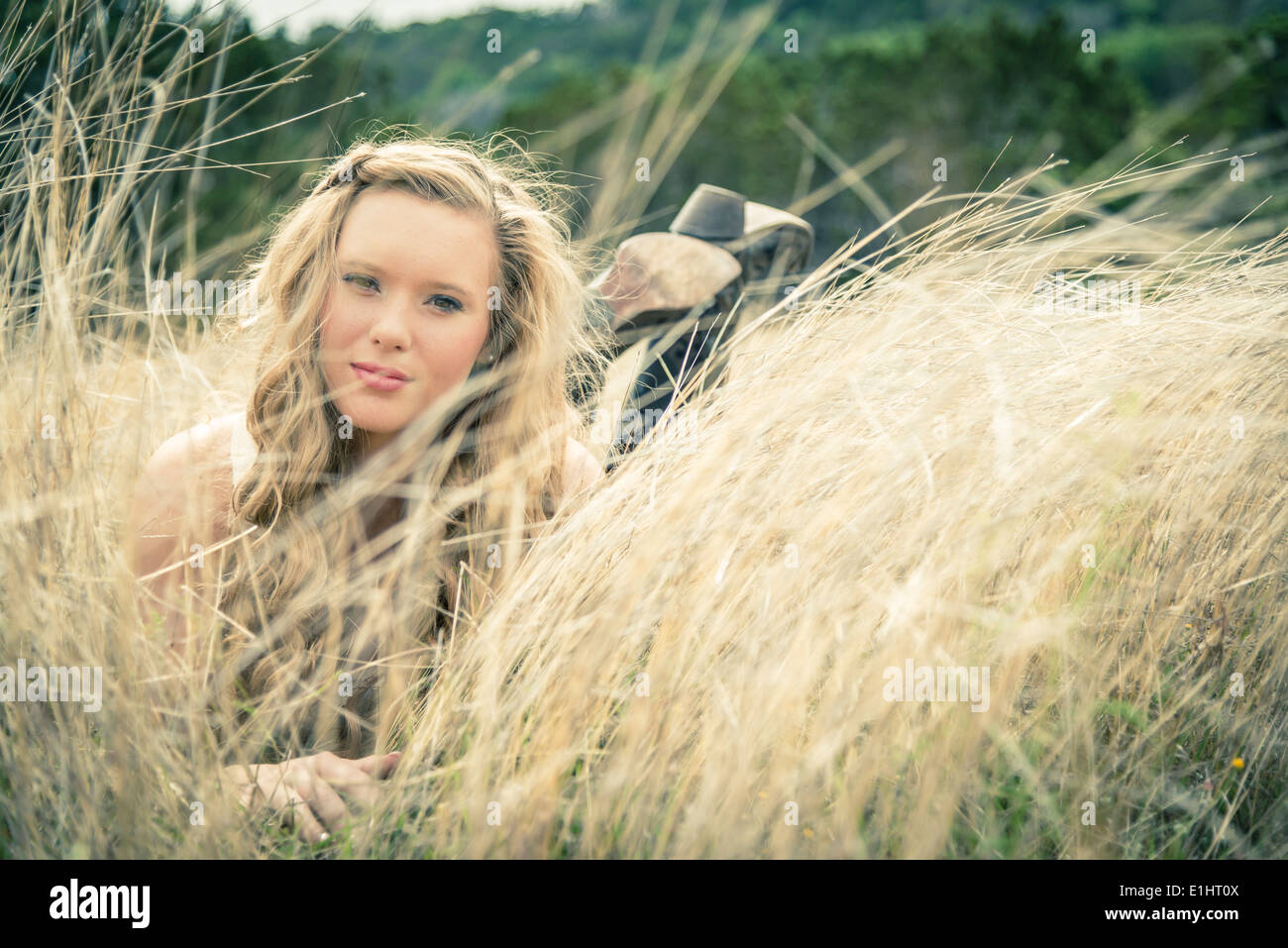 Portrait of smiling young woman lying in grass Stock Photo - Alamy