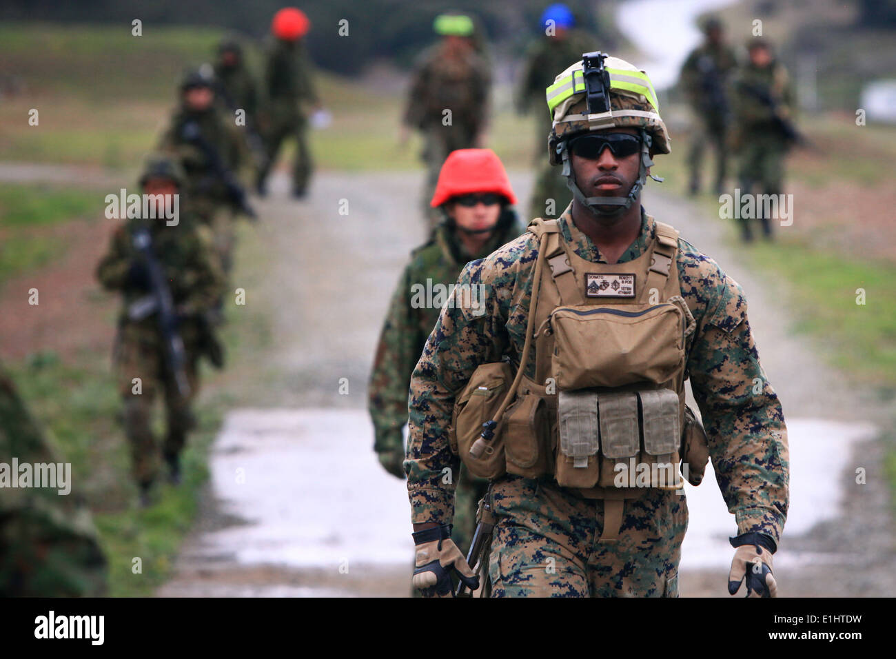 U.S. Marine Cpl. Paul Donato, rifleman with 1st Battalion, 4th Marine Regiment, 1st Marine Division, patrols with members of th Stock Photo