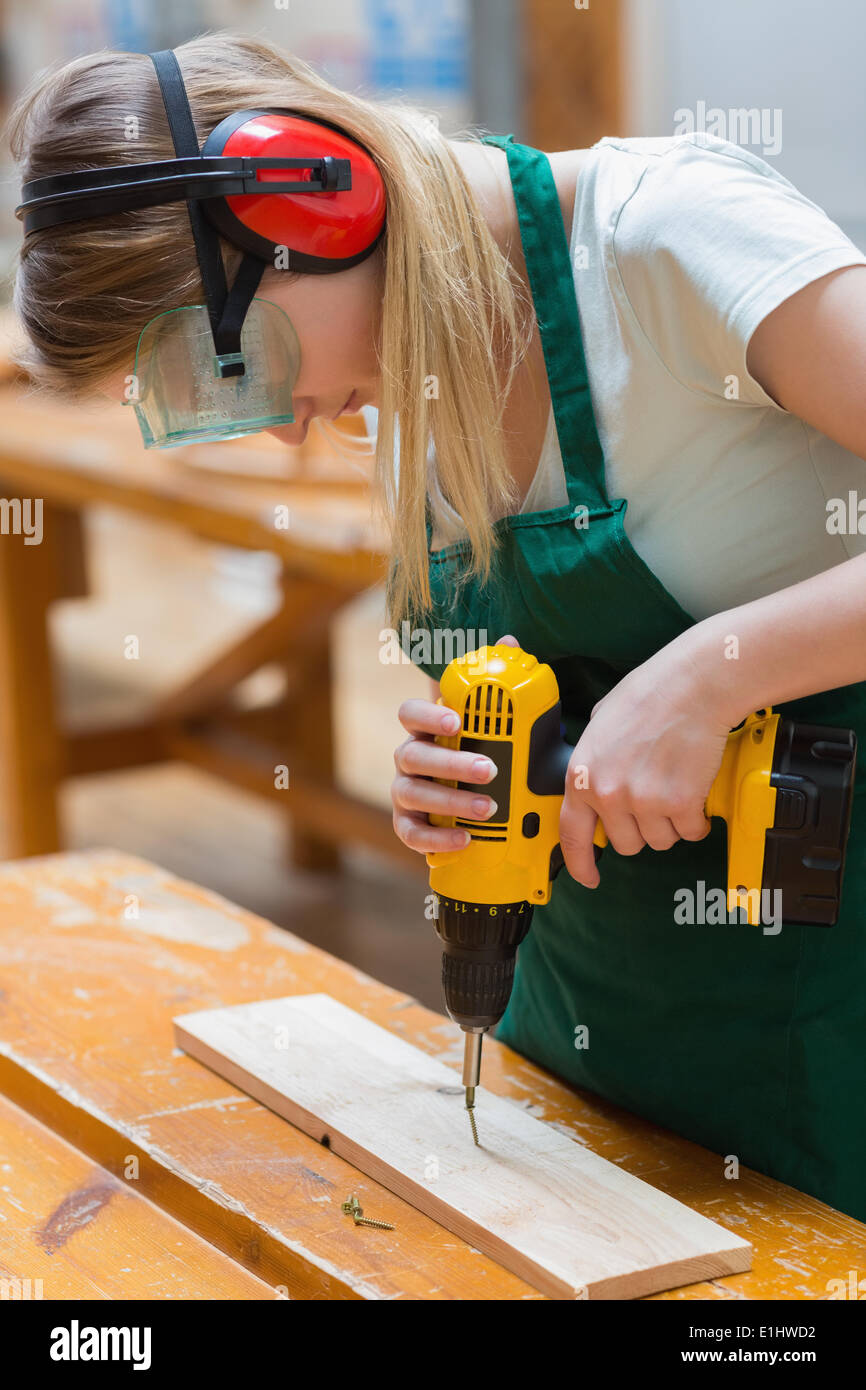 Student in a woodwork class using a drill Stock Photo
