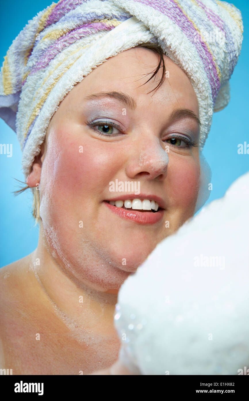 Midadult woman with towel turban and bathing foam Stock Photo Alamy