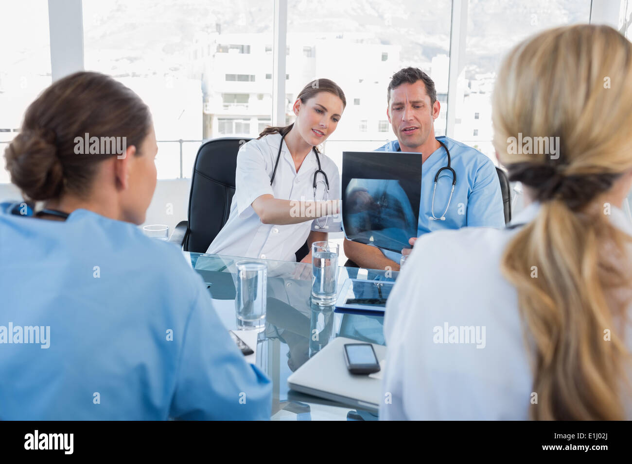 Medical team analysing a x-ray Stock Photo - Alamy