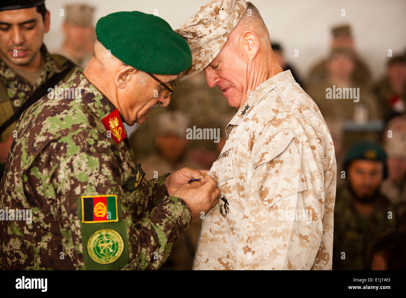 U.S. Marine Corps Maj. Gen. Charles M. Gurganus, right, receives a gift from an Afghan National Army soldier during a transfer Stock Photo