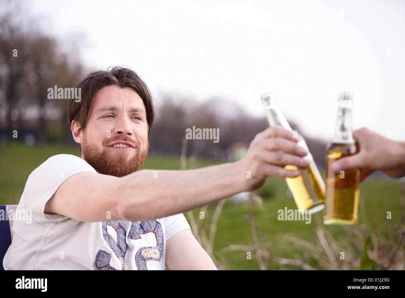 Two men holding up bottles hi-res stock photography and images - Alamy