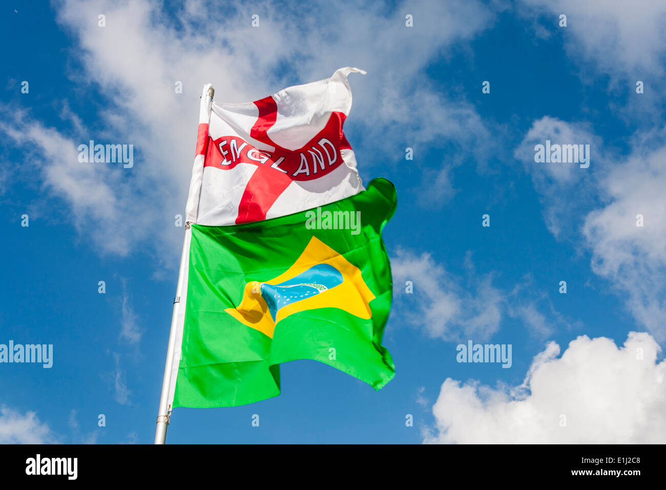 English St George's flag and Brazilian national flag fly together ahead of the 2014 football world cup. Stock Photo