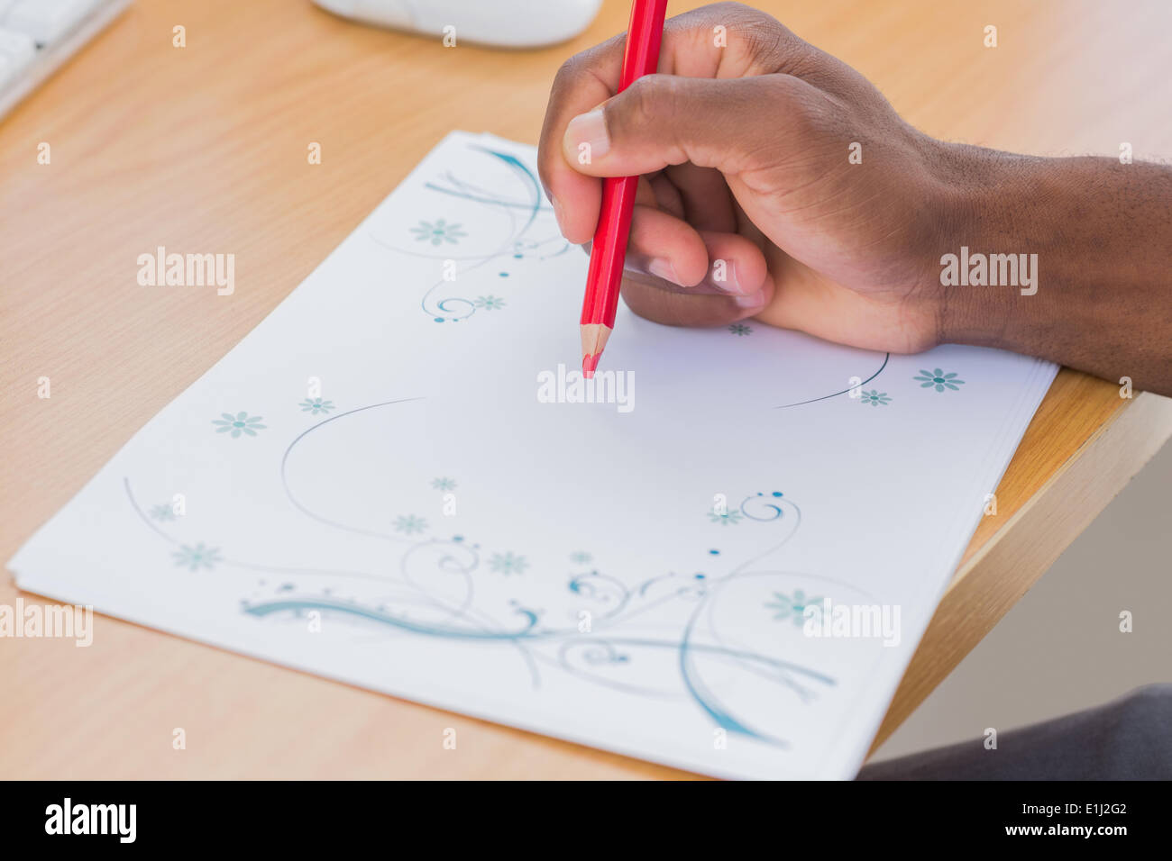 Hand with a red pencil drawing something Stock Photo Alamy