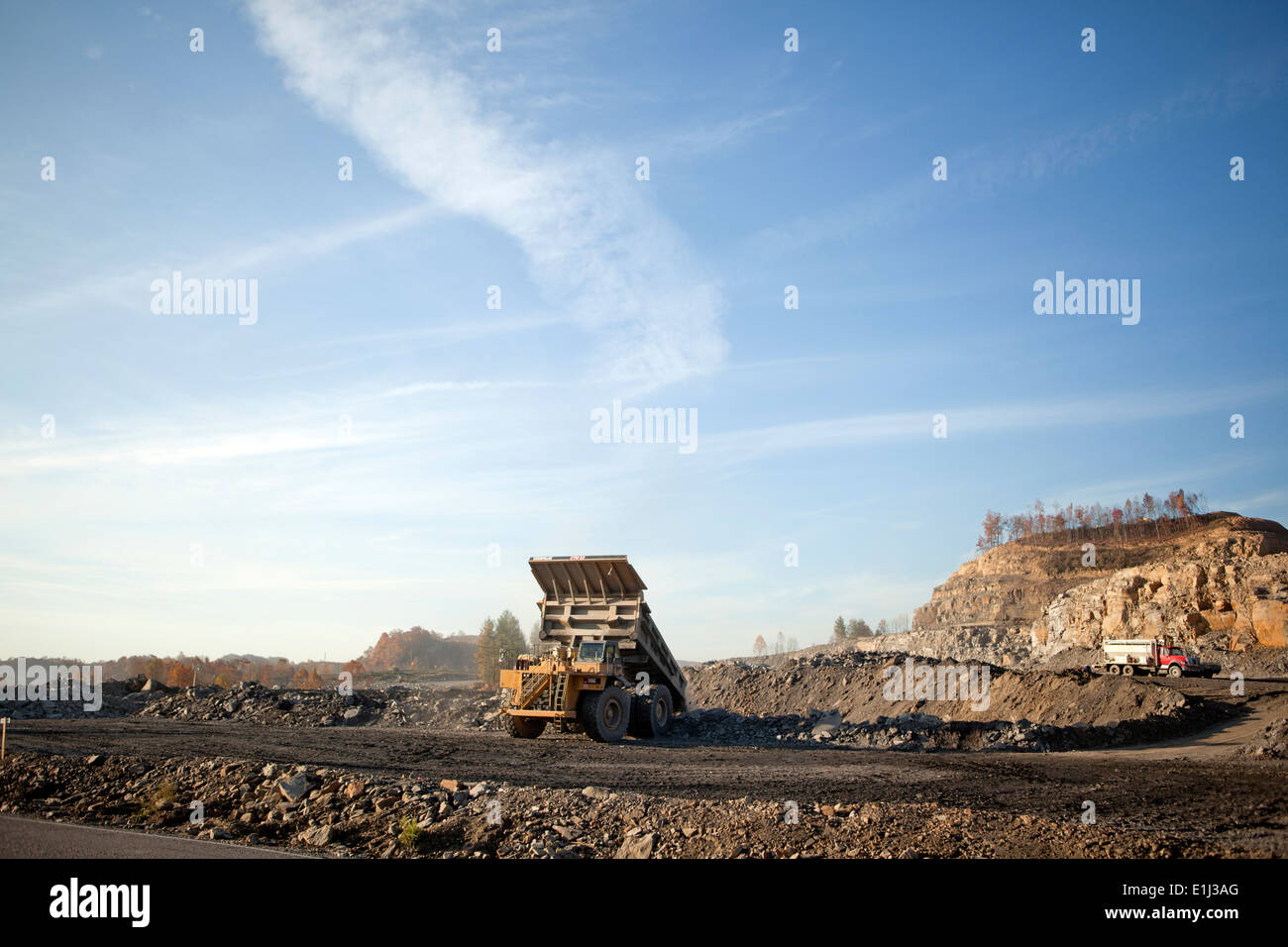 Coal mining dump trucks excavating mountaintop, Appalachia, Wise County
