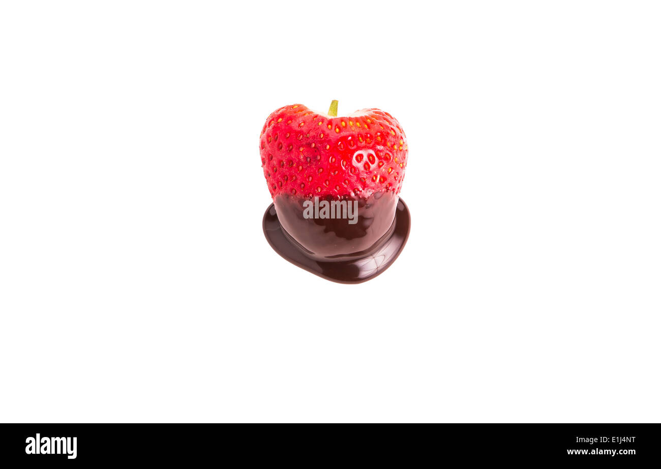 A fresh, red, ripe strawberry dipped in chocolate sauce on a white background Stock Photo