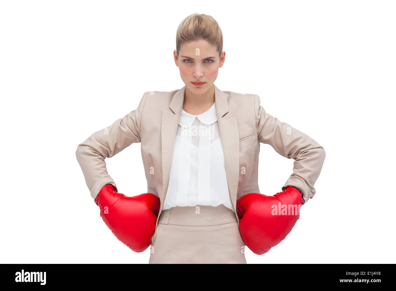 Determined businesswoman with boxing gloves Stock Photo