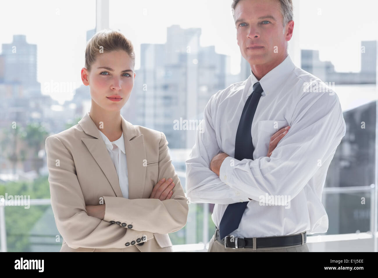 Serious business people with arms crossed Stock Photo - Alamy