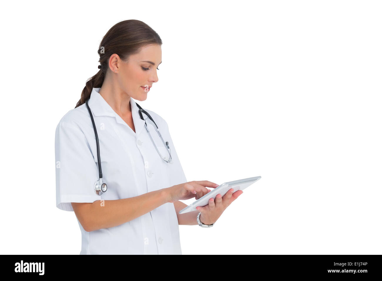 Nurse using her tablet and smiling Stock Photo - Alamy