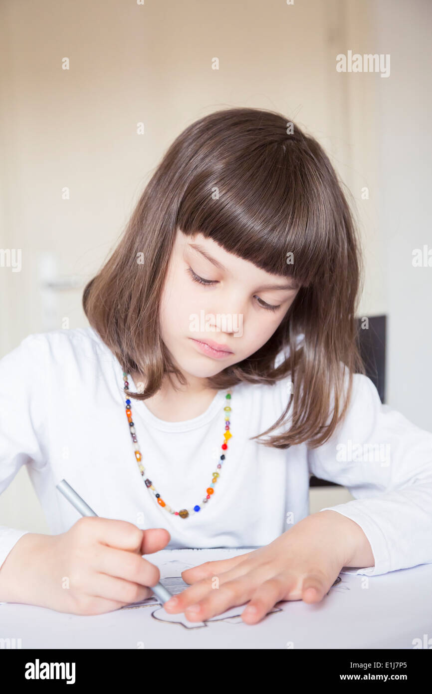 Portrait of little girl painting with wax crayon Stock Photo - Alamy