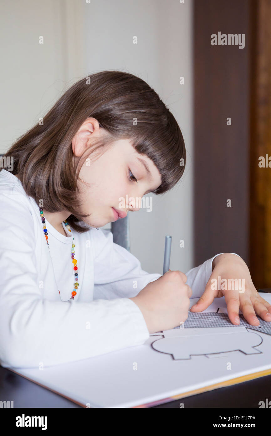 Portrait of little girl painting with wax crayon Stock Photo - Alamy
