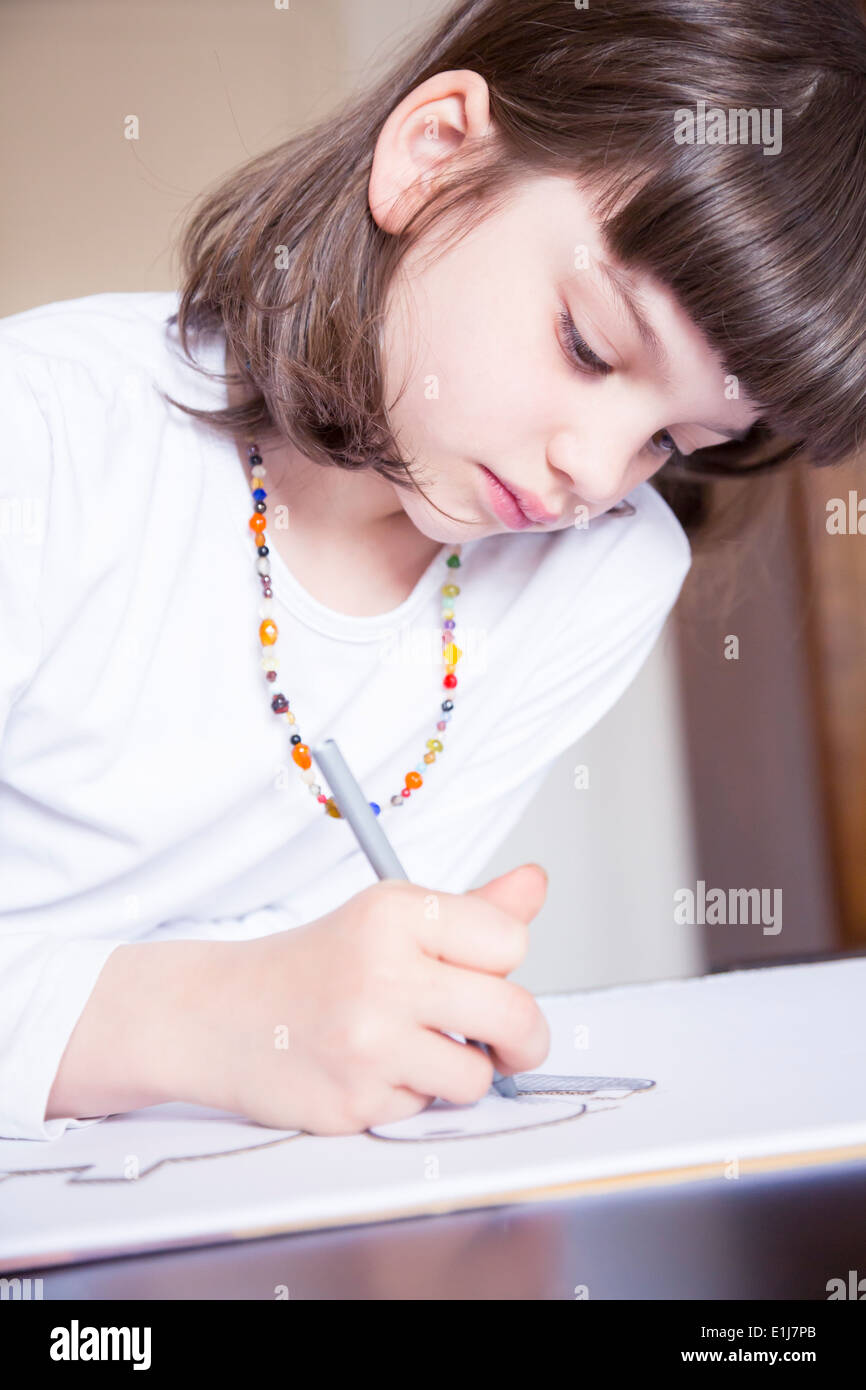 Portrait of little girl painting with wax crayon Stock Photo - Alamy