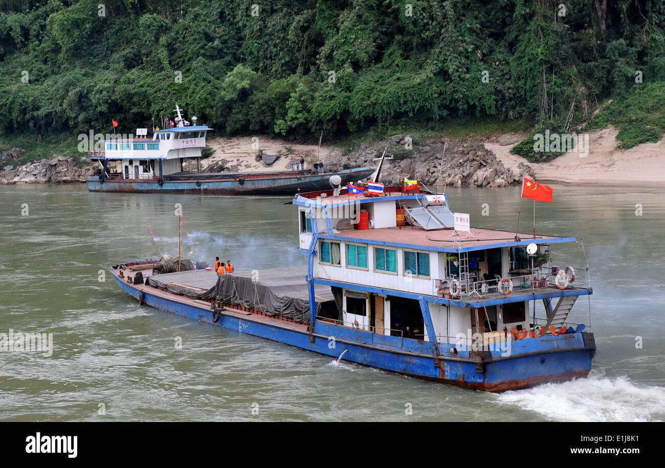 Kunming. 10th Dec, 2011. In this file photo taken on Dec. 10, 2011, a cargo ship cruises on the Mekong River near Guanlei Port in Xishuangbanna Dai Autonomous Prefecture, southwest China's Yunnan Province. Yunnan has been building a transportation network that links its three neighbours, Laos, Vietnam and Myanmar, in an attempt to raise the province's openness to Southeast Asia and the Indian Ocean. © Lin Yiguang/Xinhua/Alamy Live News Stock Photo