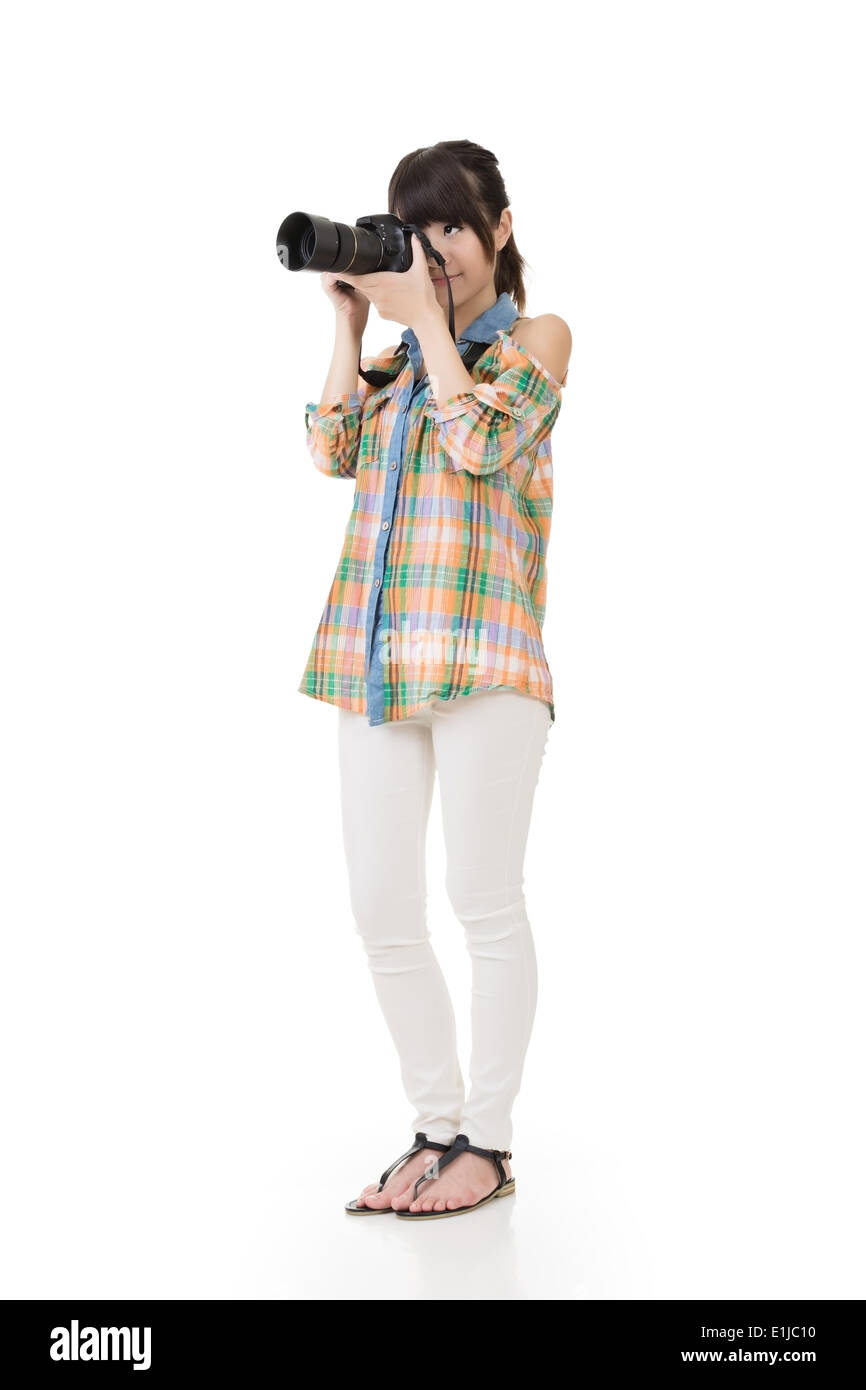 Asian woman takes pictures with photo camera Stock Photo
