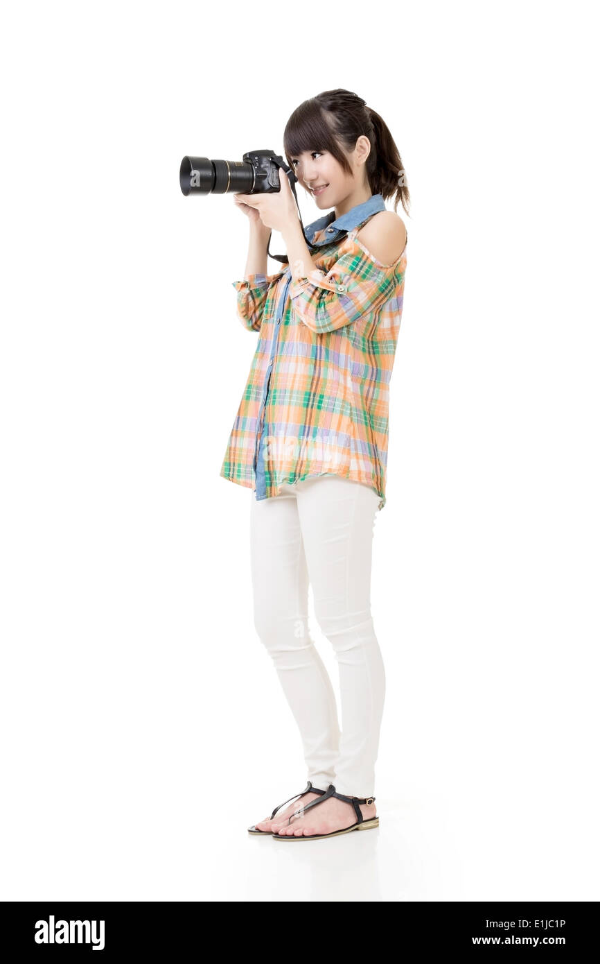Asian woman takes pictures with photo camera Stock Photo