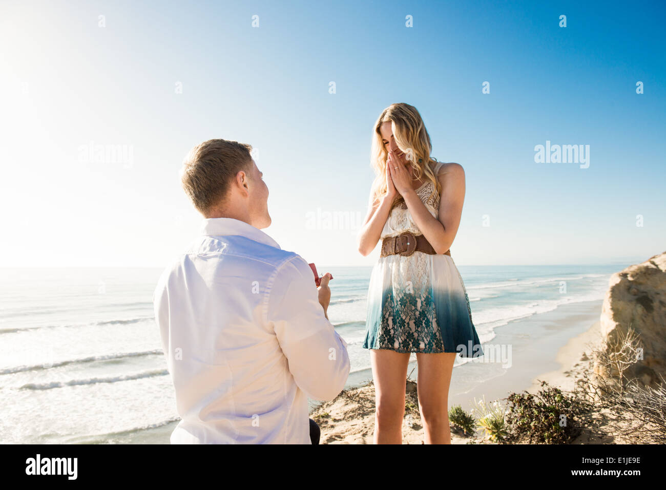 Young man proposing to girlfriend by sea, Torrey Pines, San Diego, California, USA Stock Photo