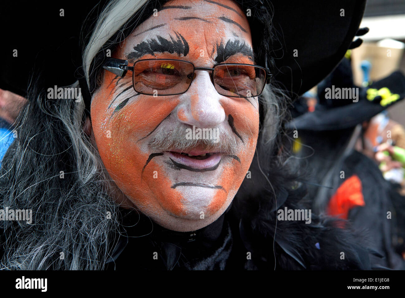 Man in orange coloured face paint, close up portrait, Ostend Carnival, Belgium Stock Photo