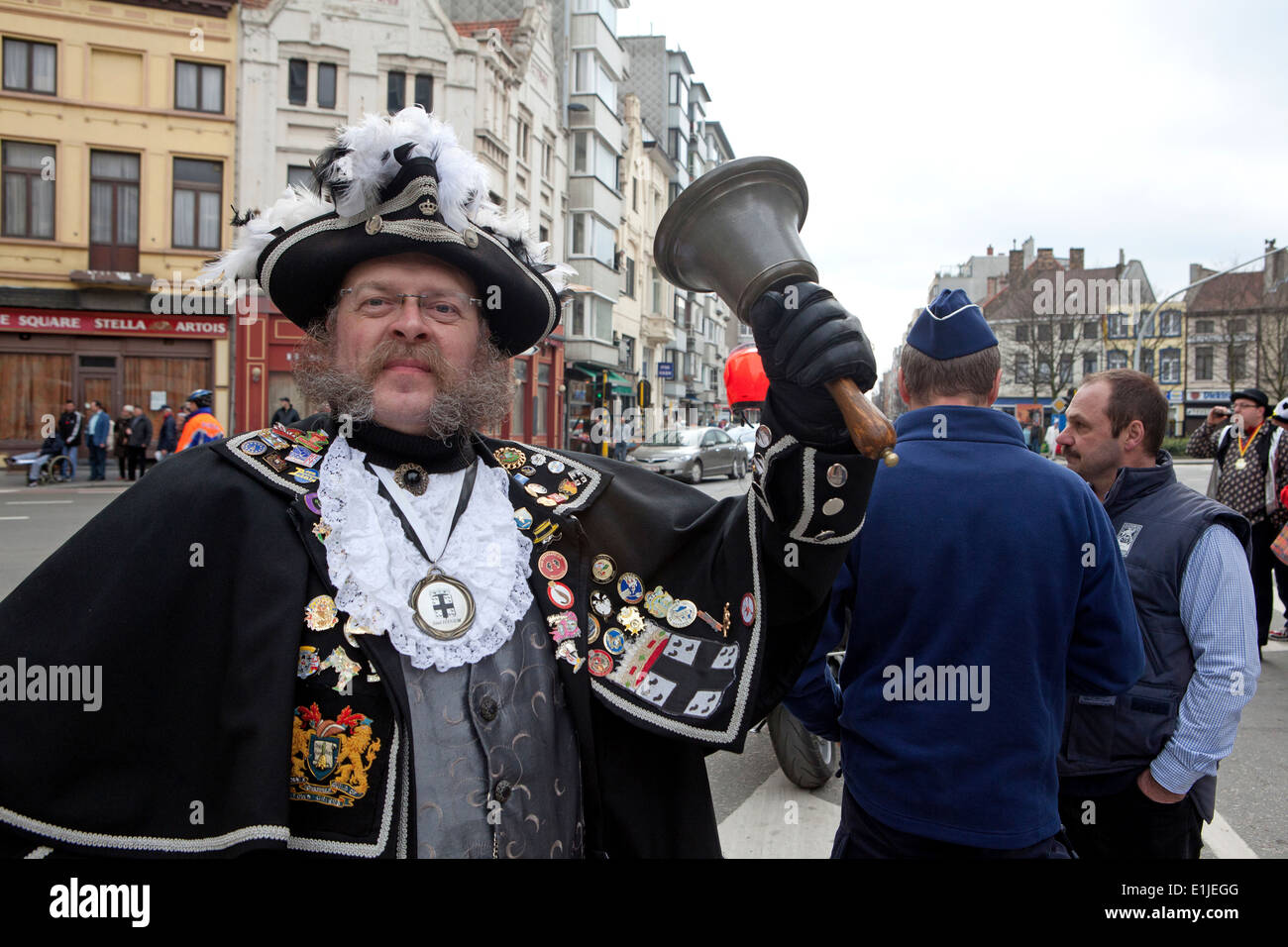 Man dressed in traditional costume with hand bell on parade at Ostend Carnival, Belgium, Portrait Stock Photo