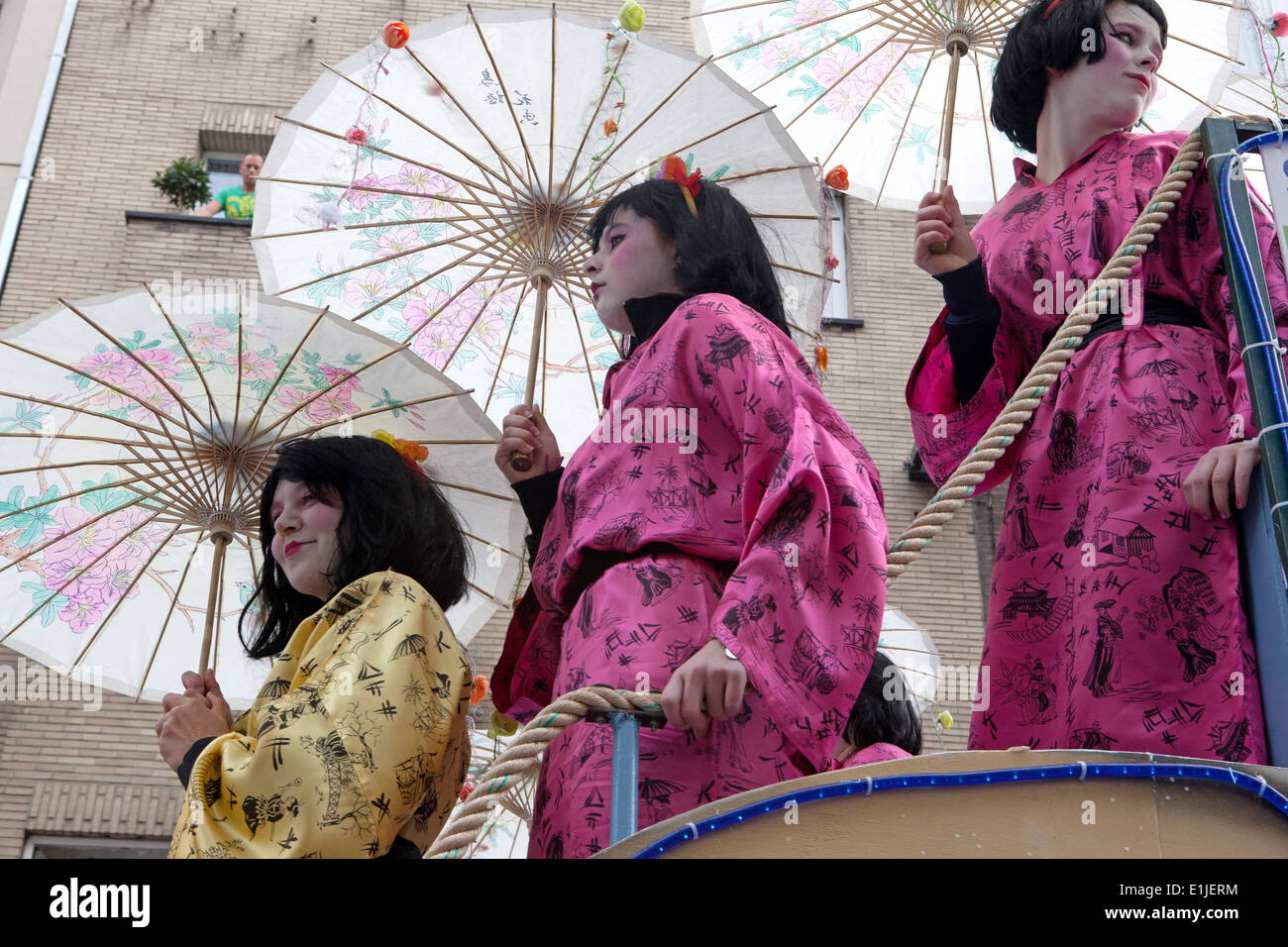 Three women in traditional Japanese kimono costumes with parasols, low angle view, Ostend Carnival, Belgium Stock Photo