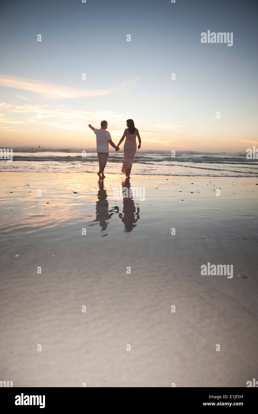 Couple holding hands beach sunset hi-res stock photography and images ...