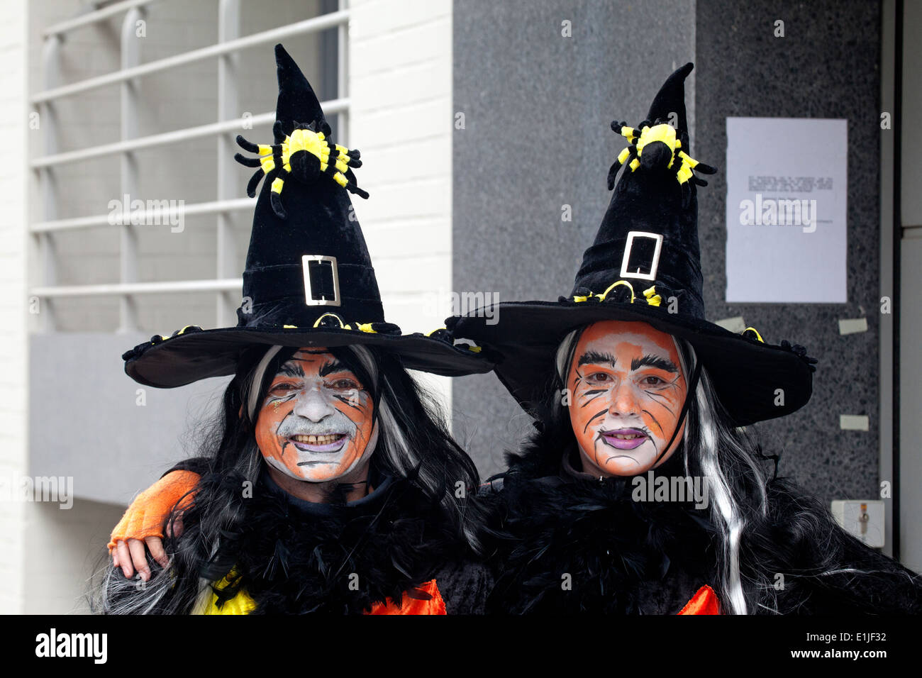 Two women parading in traditional witch costume and orange colour face paint, portrait, Ostend Carnival, Belgium Stock Photo