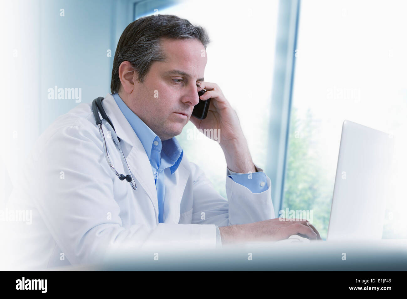 Doctor using mobile phone Stock Photo