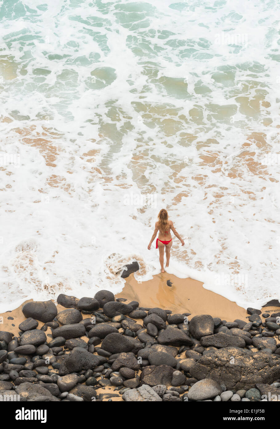 Woman walking along the beach. Fuerteventura, Canary Islands, Spain. Stock Photo