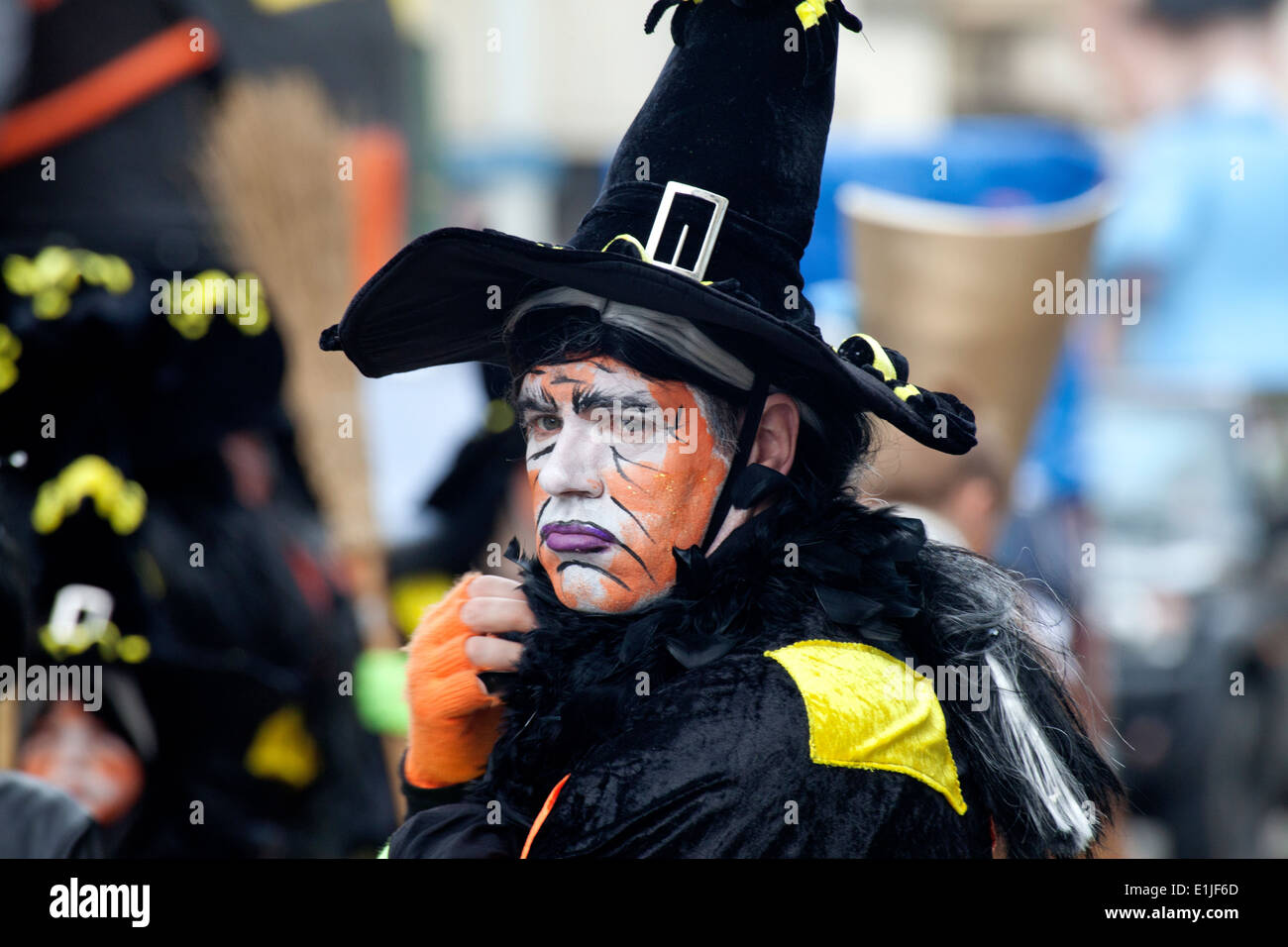 Man parading in traditional witch costume and orange colour face paint, Ostend Carnival, Belgium Stock Photo