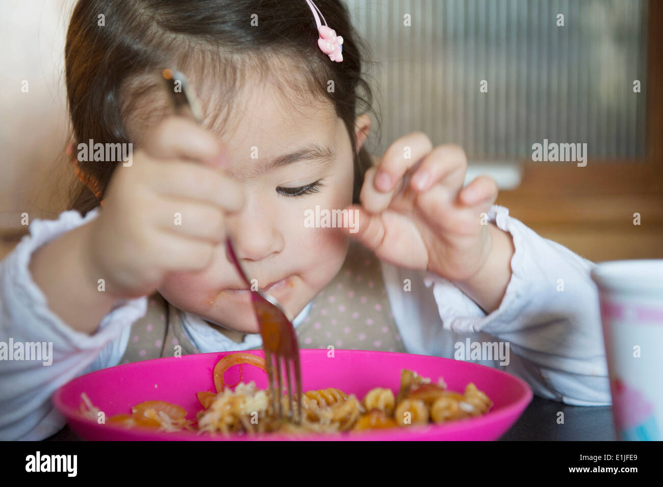Girl using fork Stock Photo