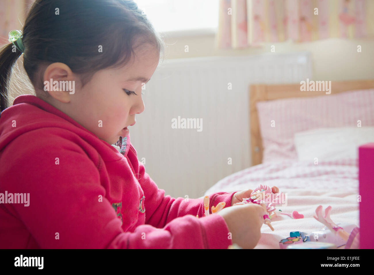 Girl playing by herself Stock Photo