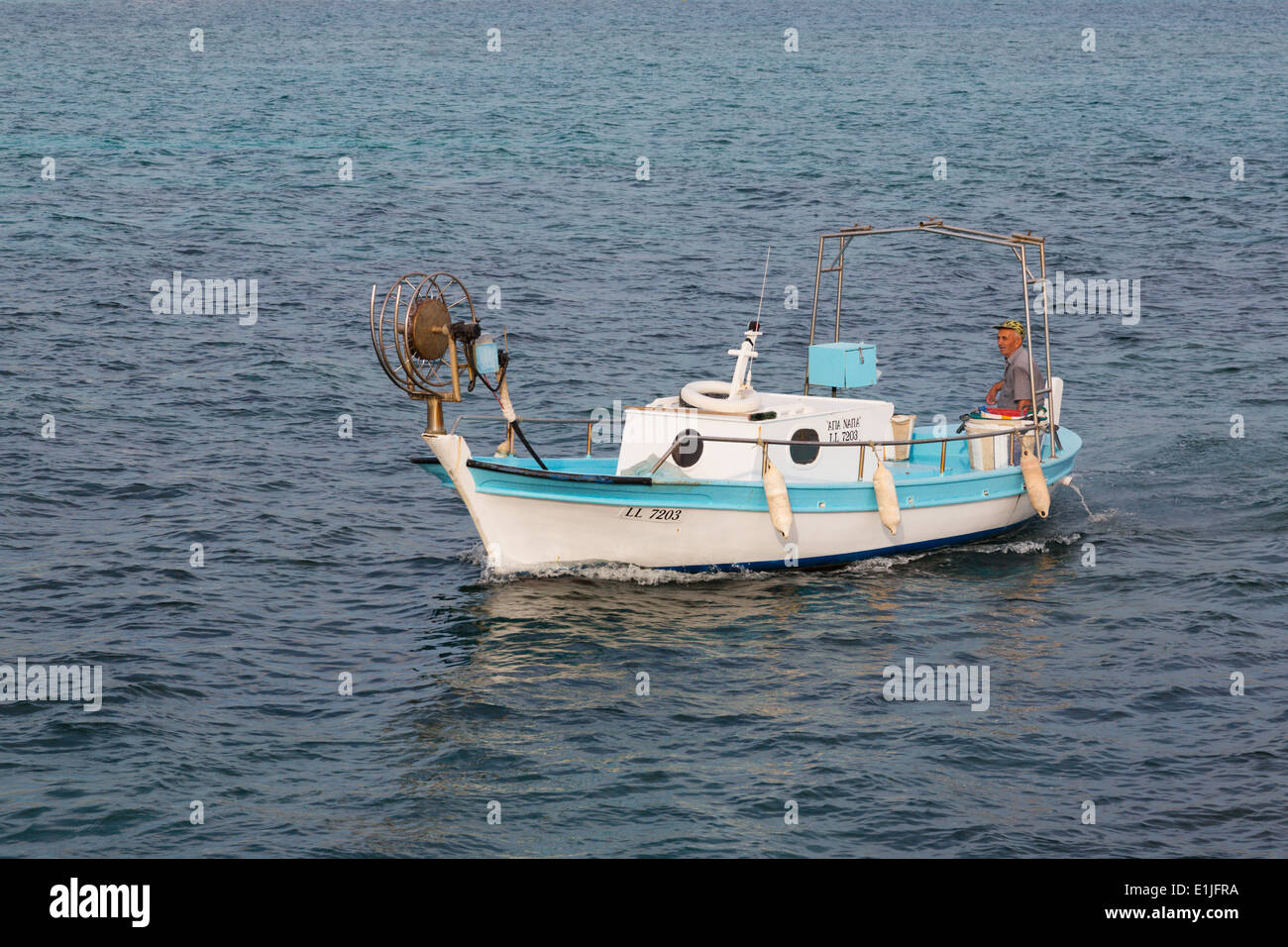 Traditional Cypriot caique fishing boat coming into Ayia Napa harbour after a days fishing, Cyprus Stock Photo