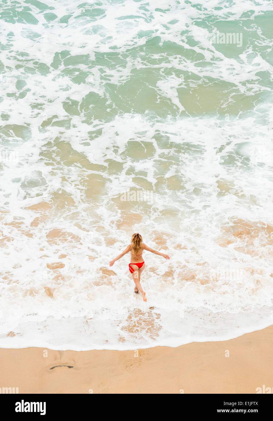 Woman running along the beach. Fuerteventura, Canary Islands, Spain. Stock Photo
