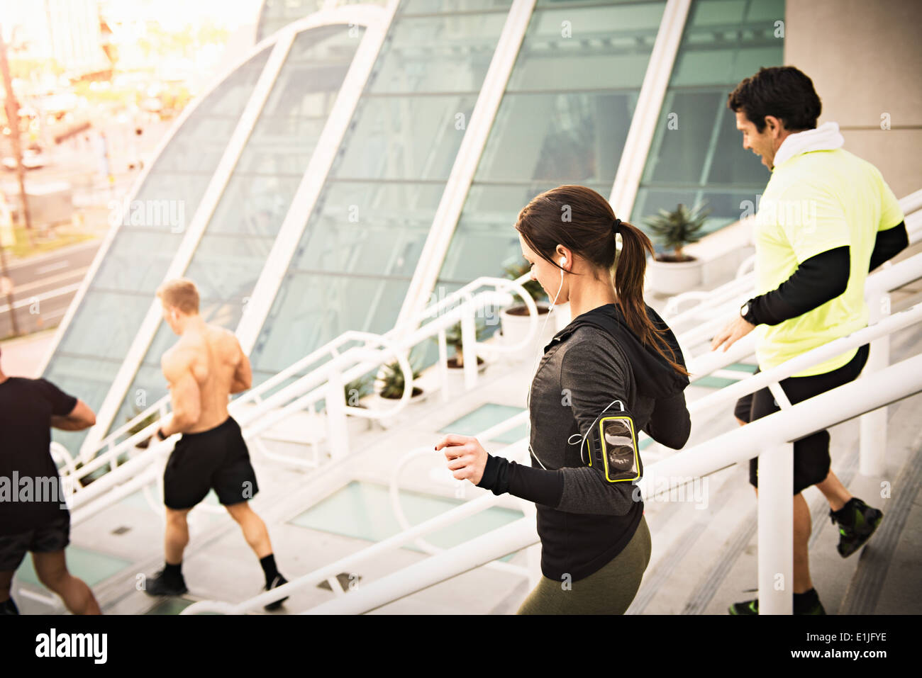 Small group of runners training on convention center steps Stock Photo
