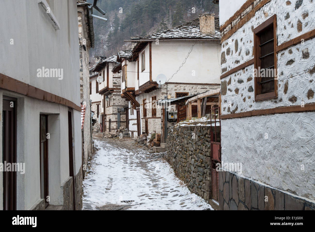 Street and buildings in the traditional village of Shiroka Laka in Bulgaria during winter Stock Photo