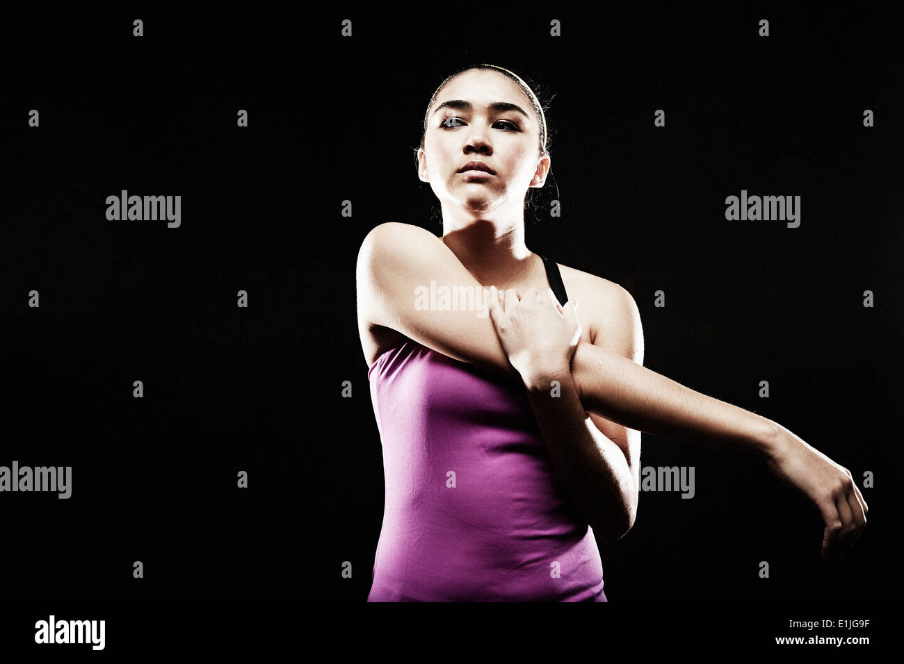 Young woman stretching arm Stock Photo