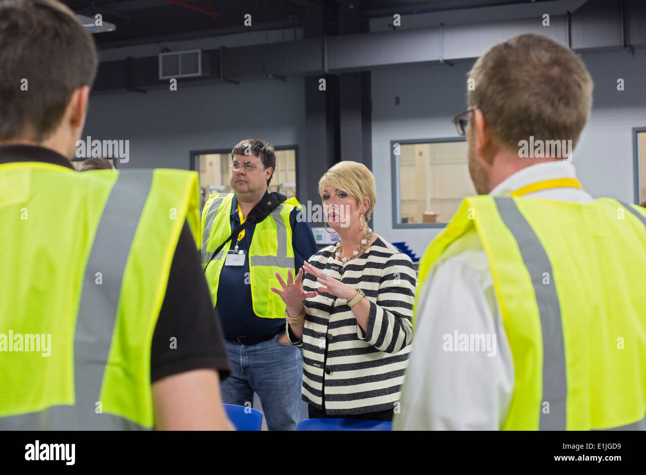 Jodi Tinson, manager of Manufacturing and Labor Communications at Chrysler, talks with reporters and photographers. Stock Photo