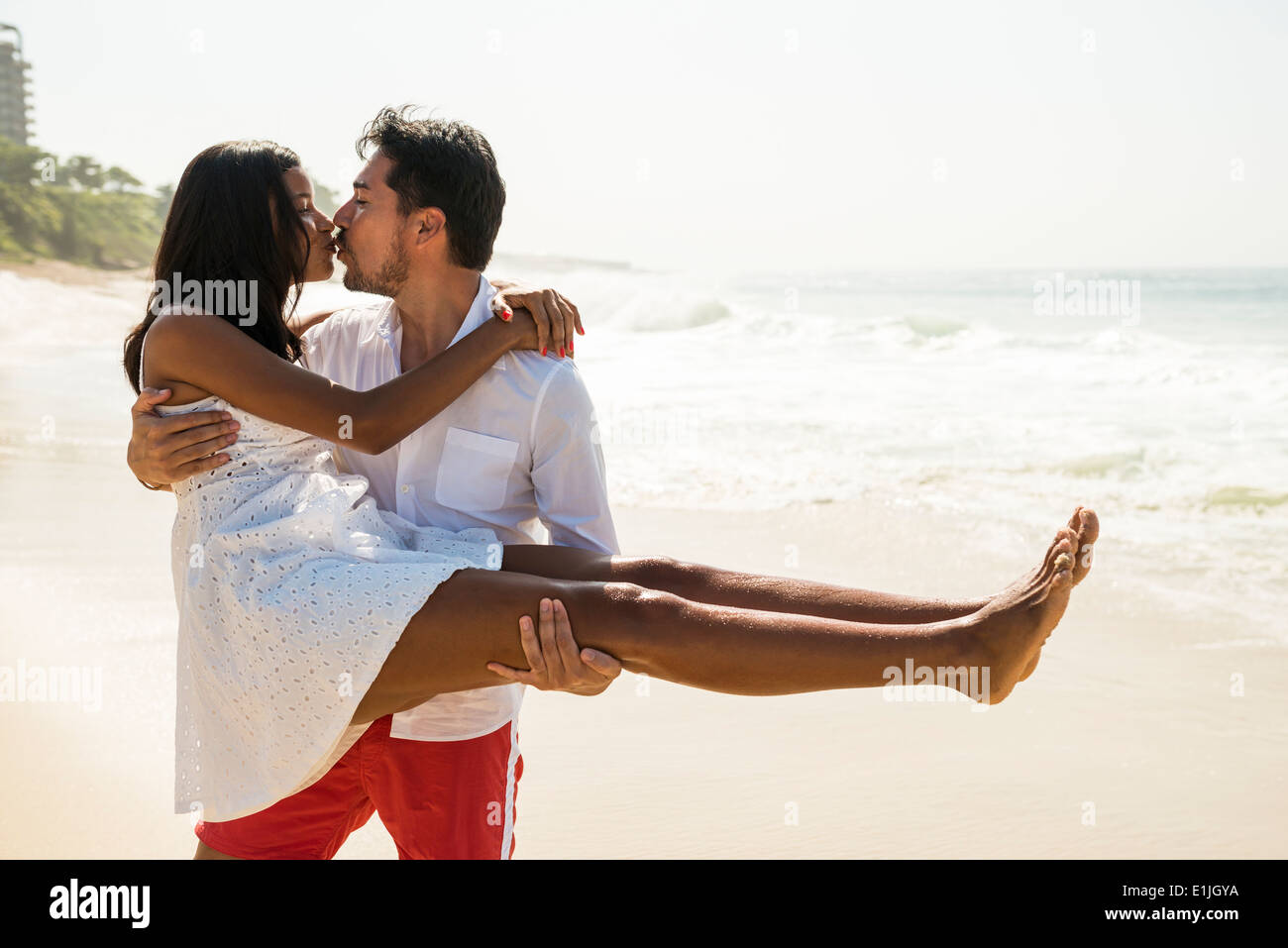 Couple kissing on Arpoador beach, Rio De Janeiro, Brazil Stock Photo