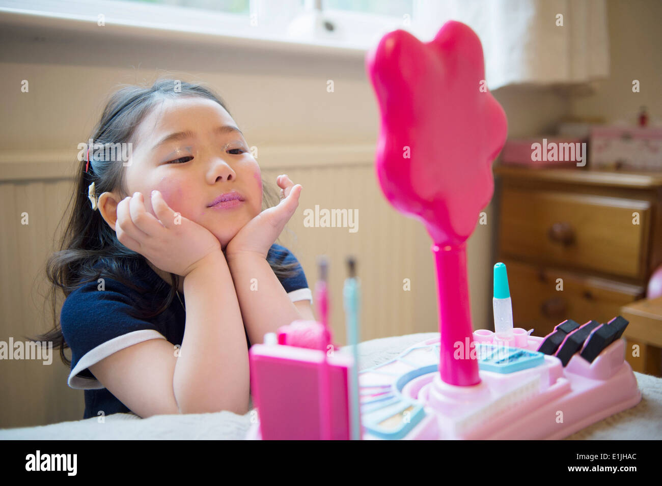 Girl putting make up on Stock Photo