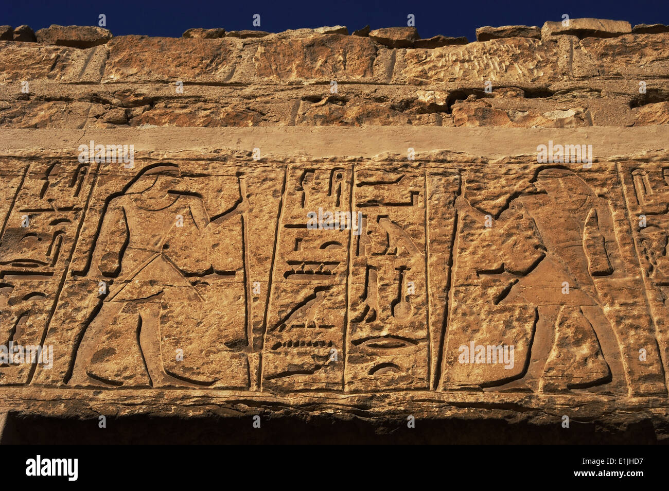 Egyptian Art. Necropolis of Saqqara. Male figures and hieroglyphs that decorate a mastaba. Relief. Entrance. Old Kingdom. Egypt. Stock Photo