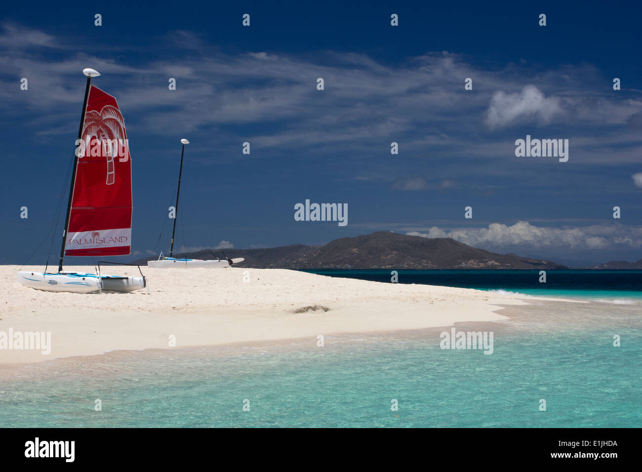 Palm Island - Red Sail, Turquoise Caribbean Ocean and Coral Sand. Stock Photo