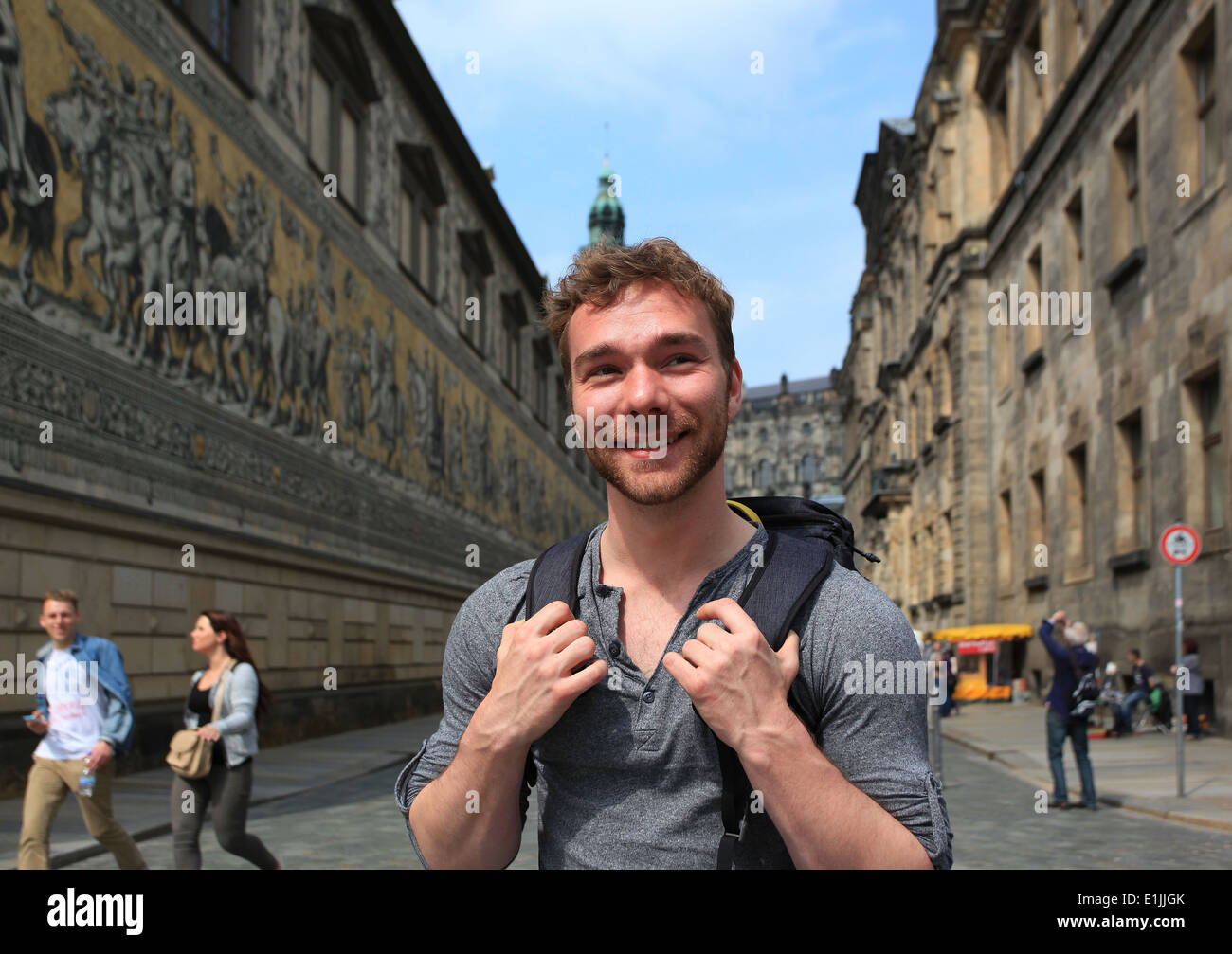 A male student visiting the Fürstenzug (Procession of Princes) in the old town of Dresden. Saxony, Germany. Stock Photo