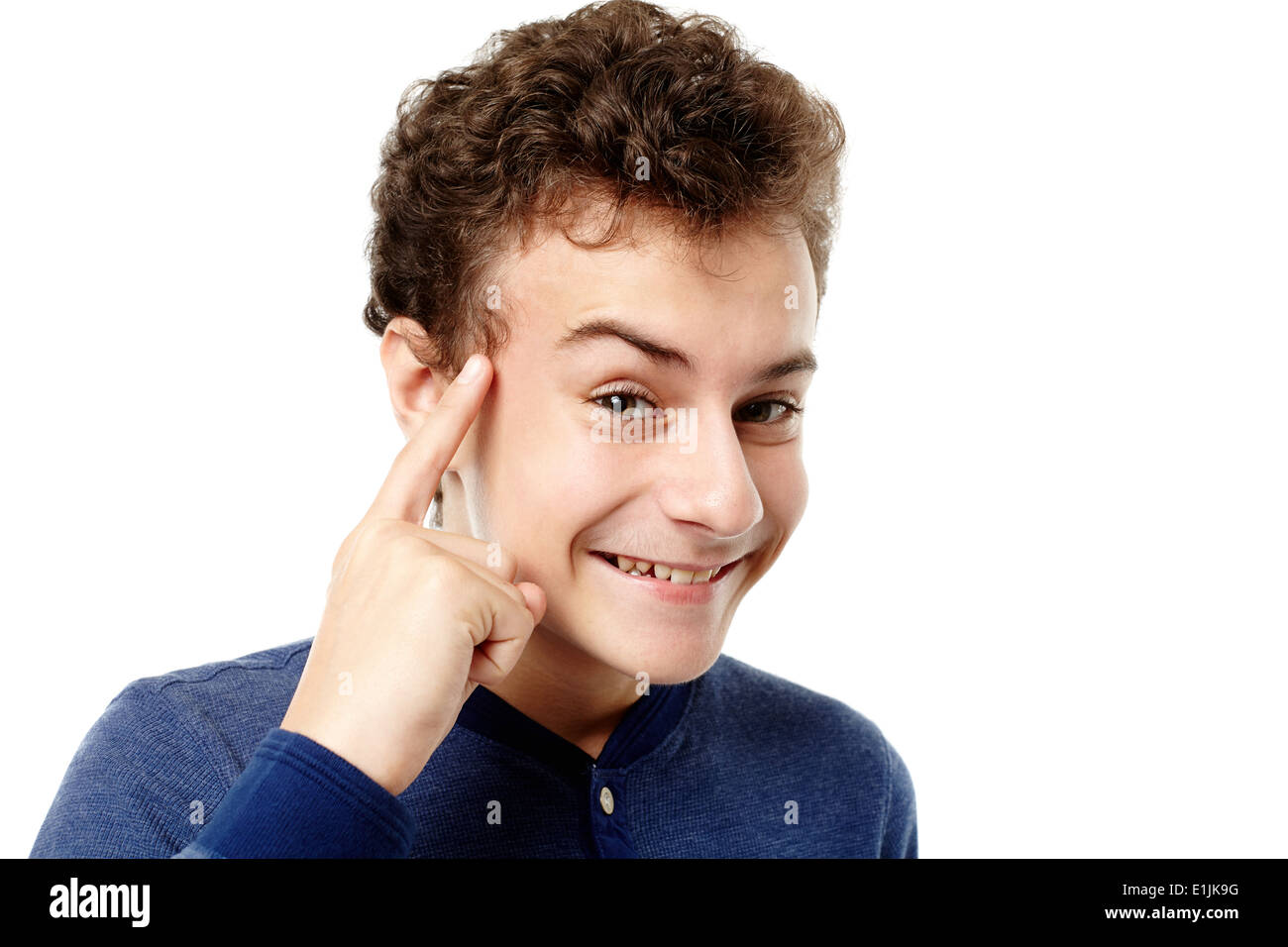 Closeup of smart teenager pointing his head with the finger having a brilliant idea, isolated over white background Stock Photo