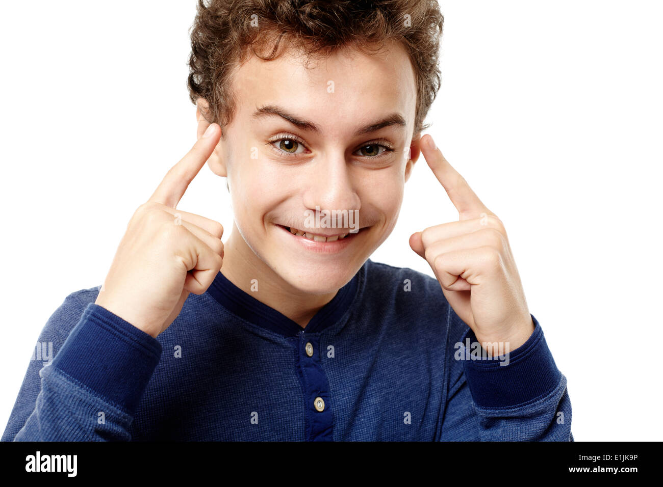 Closeup of smart teenager pointing his head with fingers having a brilliant idea, isolated over white background Stock Photo