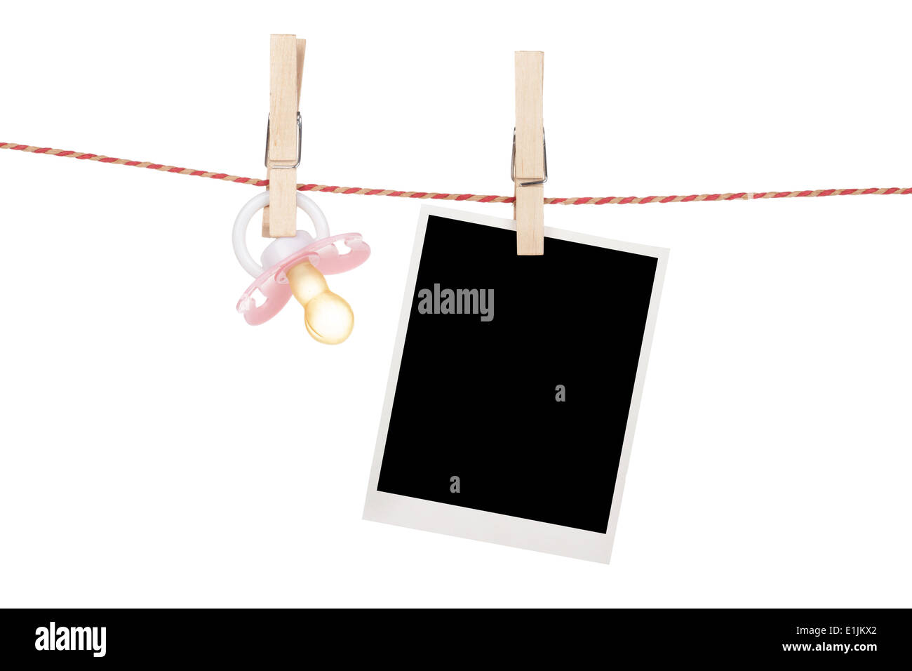 Instant photo and pacifier hanging on the clothesline. Isolated on white background Stock Photo