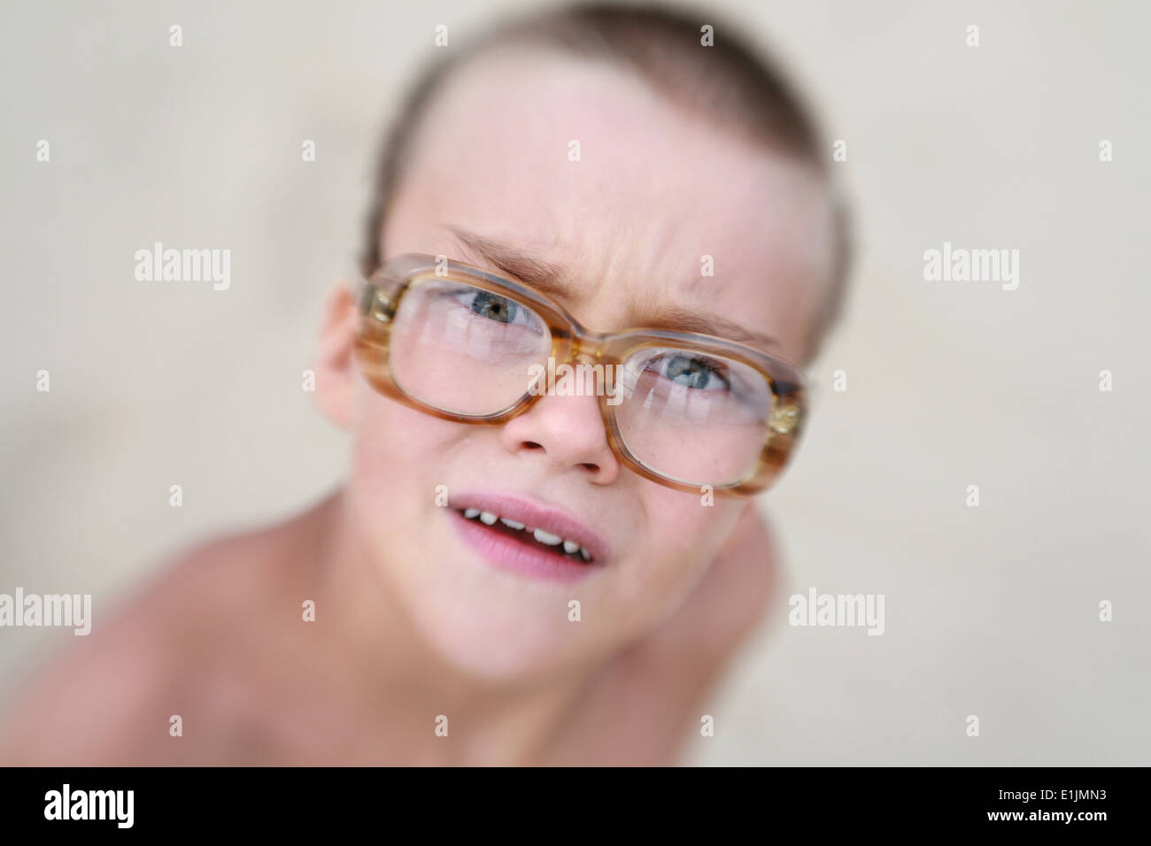 Inquisitive interested funny boy in glasses with horn-rimmed glasses with diopters. Original name: 'And why?' Stock Photo